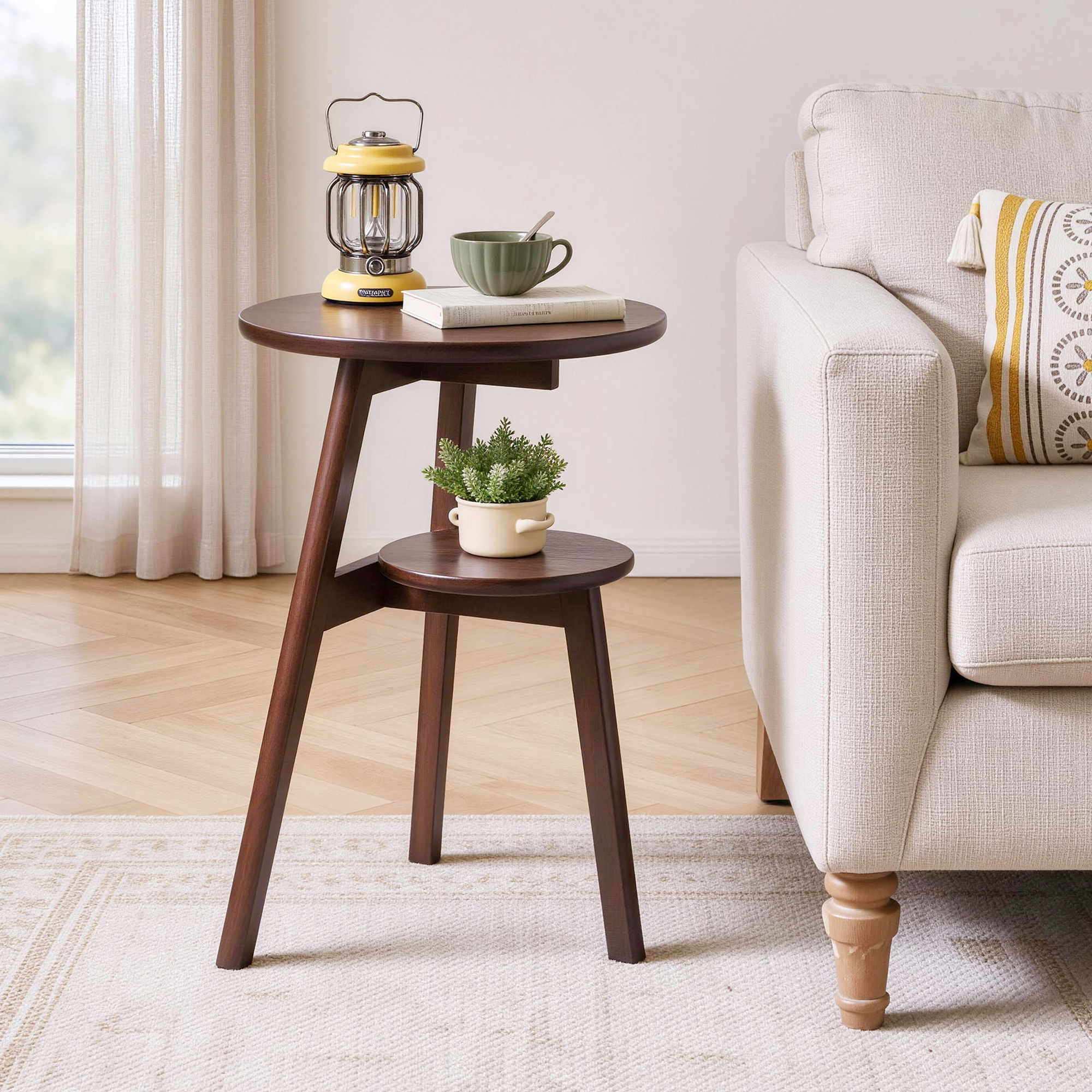 Walnut 2-tier round side table with a lantern and mug on top and a succulent plant on the lower shelf