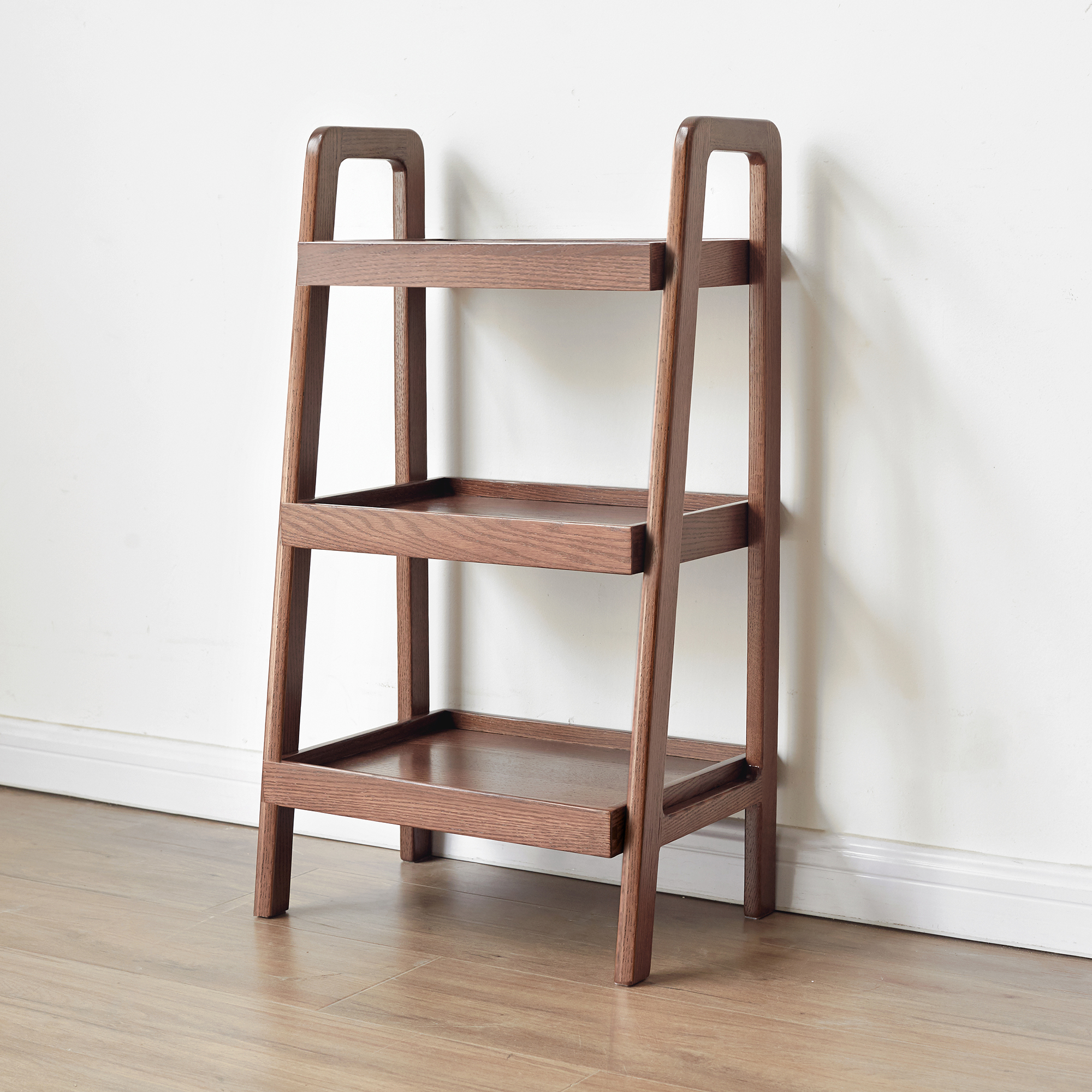 Walnut finish ladder shelf full view against a white wall