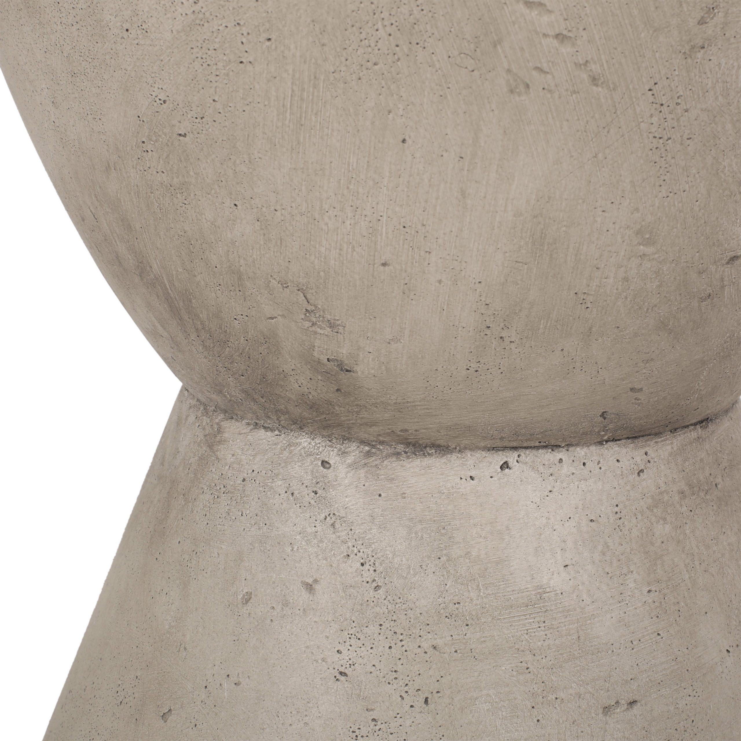 Close-up of the hourglass base joint and cast concrete texture of the side table