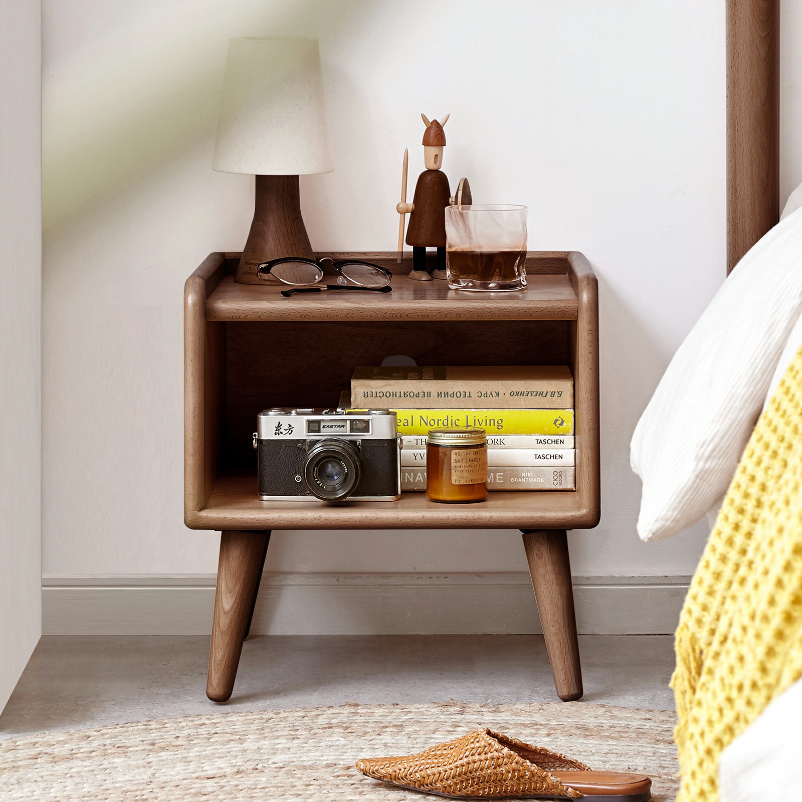 Walnut nightstand styled in a bedroom with lamp and table decor