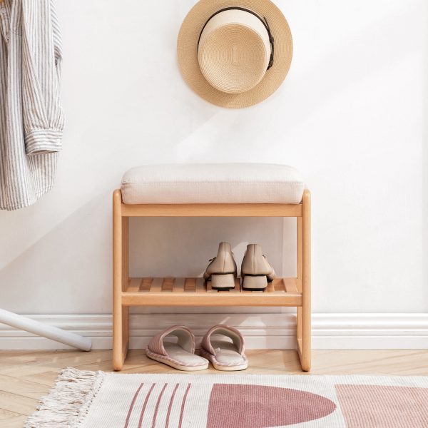 Beech wood shoe bench with cushioned seat and slatted shelf in a bright entryway
