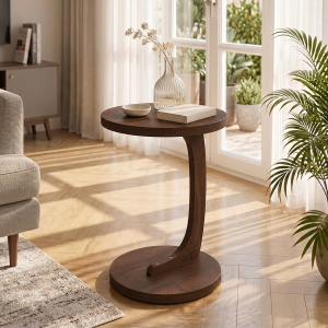 C shaped end table in walnut wood grain beside a sofa in a small living room