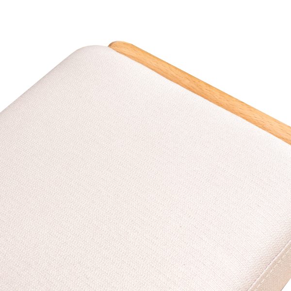 Close-up of the beige fabric cushioned seat on the beech wood shoe bench