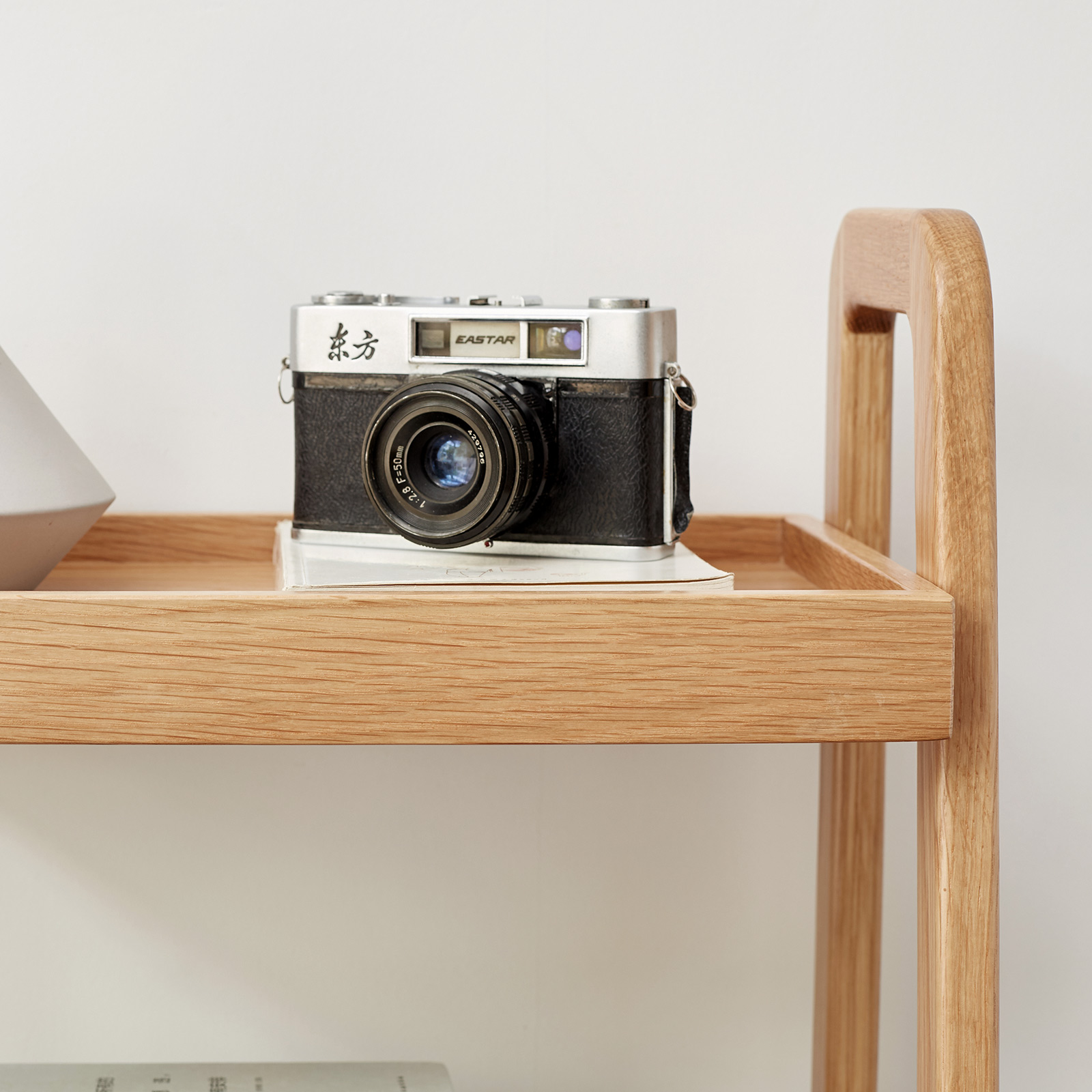 Solid wood bookshelf tier close-up with smooth rounded corners