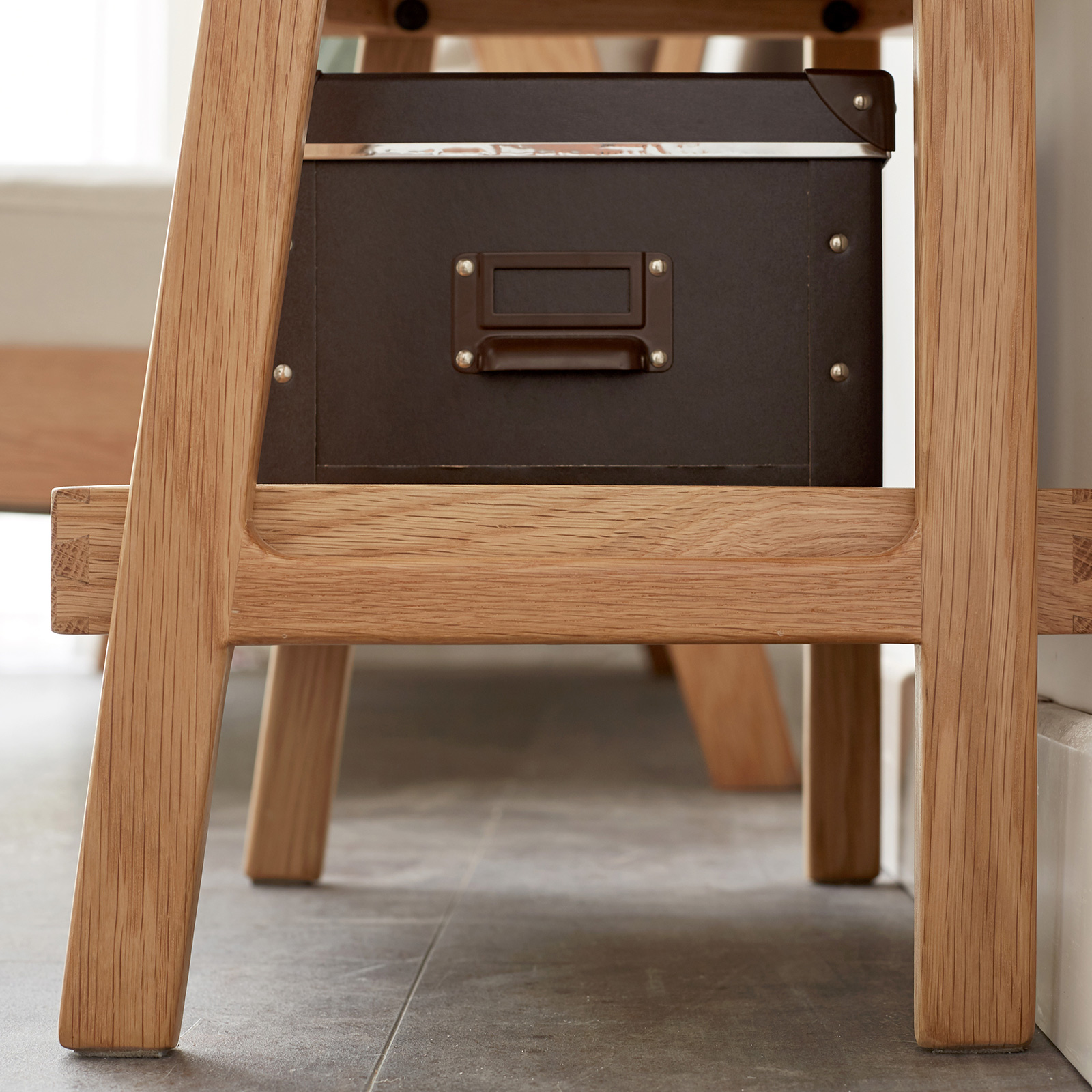 Oak ladder shelf in a small living room corner